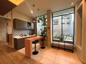 a kitchen with a counter and a large window at Apartasuite Cowork in Bogotá