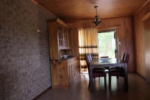 a dining room with a table and chairs and a brick wall at Willunga Farm Retreat in Willunga