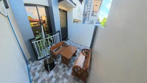 a room with a bench on a balcony at CLBC Residences 1A in Ibaba