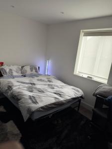 a bed in a bedroom with a window at Holiday Haven in Potters Bar