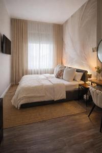 a bedroom with a large bed and a window at Pension Zur Alten Post in Havelberg