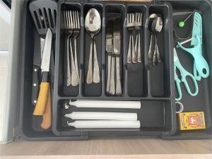 a black plastic container filled with utensils and spatulas at Casa Tronos in San Isidro de los López