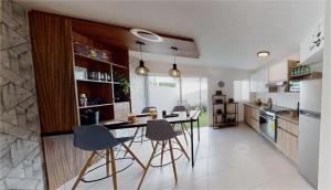 a kitchen with a table and chairs in it at Casa Tronos in San Isidro de los López