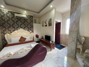 a bedroom with a large bed and a tv at King hotel in Dĩ An