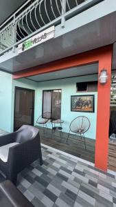 a patio with chairs and tables in a building at Villas Lux Arenal in Fortuna