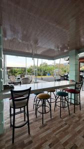 a dining room with a large table and chairs at Villas Lux Arenal in Fortuna