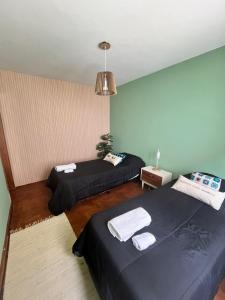 a bedroom with two beds in a room at Peonía Tempo in Esquel +10 photos