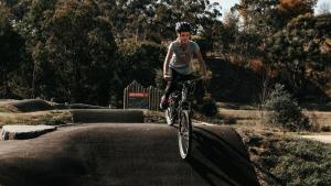 a man on a bike jumping over a ramp at Omeo Holiday Park in Omeo