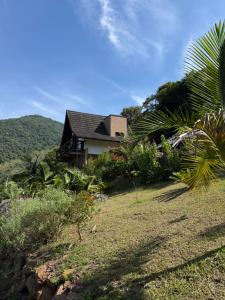 a house on the side of a hill with trees at Cabana Valle Pietra in Nova Petrópolis
