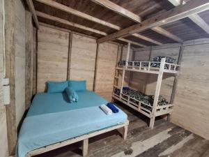 a bed in a room with a bunk bed at Baho Farm Stay in Gunungsitoli