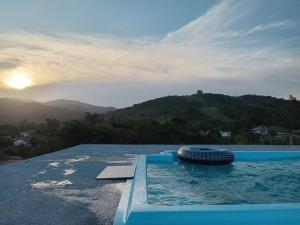 a swimming pool with a tire in the water at Recanto do sol in Imaruí