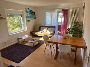 a living room with a table and a couch at Cosy Apartment in Aadorf