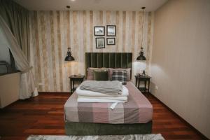 a bedroom with a bed with blankets and pillows at Pearly 16 in Putrajaya