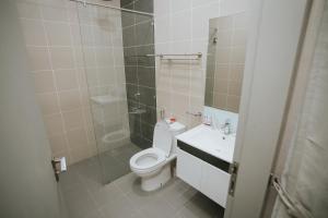 a bathroom with a toilet and a sink and a shower at Pearly 16 in Putrajaya +7 photos