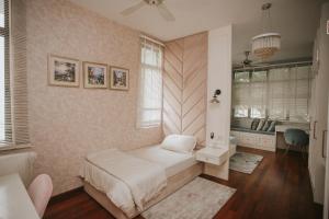 a bedroom with a bed and a desk in it at Pearly 16 in Putrajaya