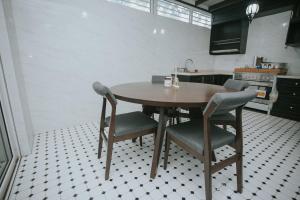 a kitchen with a wooden table and chairs at Pearly 16 in Putrajaya