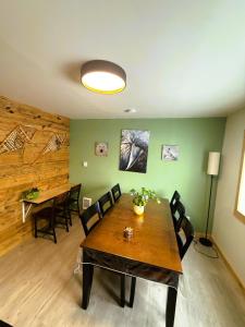 a dining room with a wooden table and chairs at Caribou Cottage in Churchill