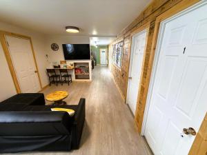 a living room with a black couch and a white door at Caribou Cottage in Churchill