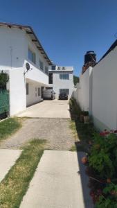 a driveway of a house with a car parked at Complejo belgrano in General Roca