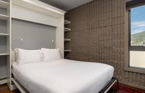 a white bed in a room with a window at Vail 21 - CoralTree Residence Collection in Vail