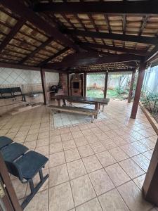 a room with a ping pong table and chairs at Moto GP sobrado in Goiânia
