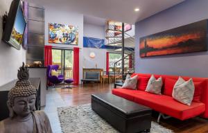 a living room with a red couch and a statue at Vail 21 - CoralTree Residence Collection in Vail