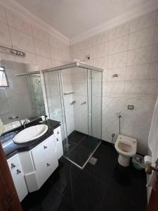 a bathroom with a shower and a sink and a toilet at Moto GP sobrado in Goiânia +8 photos