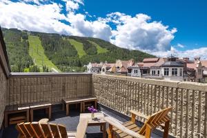 a balcony with a table and chairs and a view of a mountain at Vail 21 - CoralTree Residence Collection in Vail +49 photos