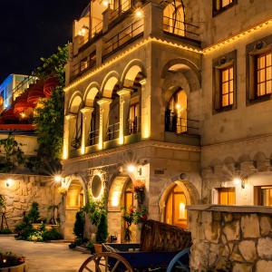 a building with a bench in front of it at night at Cratus Stone Palace in Göreme