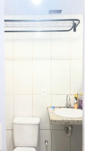 a bathroom with a toilet and a sink at Na Ladeira Studio 06 in Rio de Janeiro