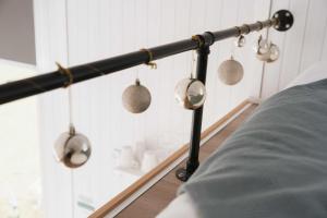 a black pole with several measuring cups on a wall at Sweet Hart 1 by Tiny Away in Tamahere