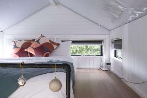a bedroom in a tiny house with a bed at Sweet Hart 1 by Tiny Away in Tamahere