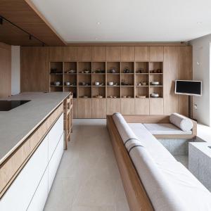 a kitchen with a couch and a tv on a wall at Goyuhanga in Busan