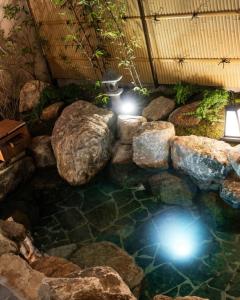 a pool of water with rocks and lights at Goyuhanga in Busan
