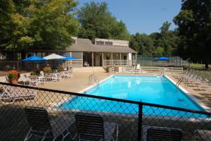 a swimming pool with chairs and tables and umbrellas at Private Mountain Condo in Wintergreen