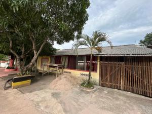 a building with a table in front of a fence at Quarto Boto Tucuxi in Santarém