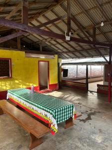 a room with a bed and a bench in it at Quarto Boto Tucuxi in Santarém