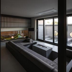 a living room with a large couch and a large window at Goyuhanga in Busan +61 photos