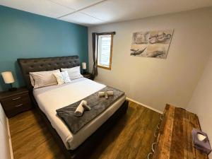 a bedroom with a bed with shoes on it at Beluga Beach House in Churchill