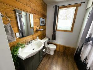 a bathroom with a sink and a toilet and a mirror at Beluga Beach House in Churchill +11 photos