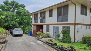 a house with a car parked in front of it at Panatina Hilltop Downstairs Unit in Honiara