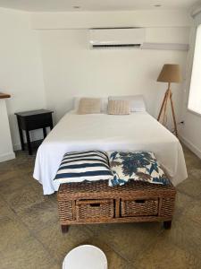 a bedroom with a bed and a table with a lamp at Casa Azul in San Pedro