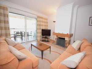 a living room with a couch and a fireplace at Sunny Balcony Apartment and Pool in Vilamoura