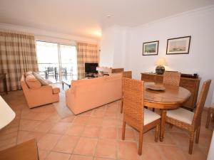a living room with a table and a dining room at Sunny Balcony Apartment and Pool in Vilamoura
