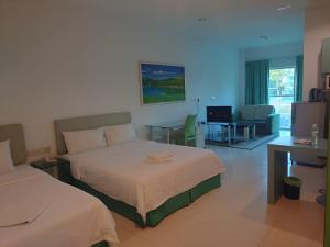 a hotel room with two beds and a living room at Santorini Hotel in Miri +55 photos