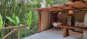 a wooden pergola with a bench on a deck at Casa Irmã Lua in Porto Seguro