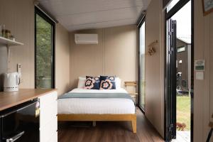 a bedroom with a bed in a small room at Sweet Hart 2 by Tiny Away in Tamahere