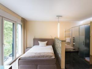Postel nebo postele na pokoji v ubytování Design-Konferenzhotel & Restaurant Steinernes Schweinchen