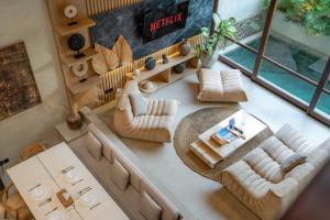 an overhead view of a living room with couches at Unwind Villa by Betterplace in Canggu