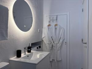 a white bathroom with a sink and a mirror at Villa Alta Vista in São Jorge +107 photos